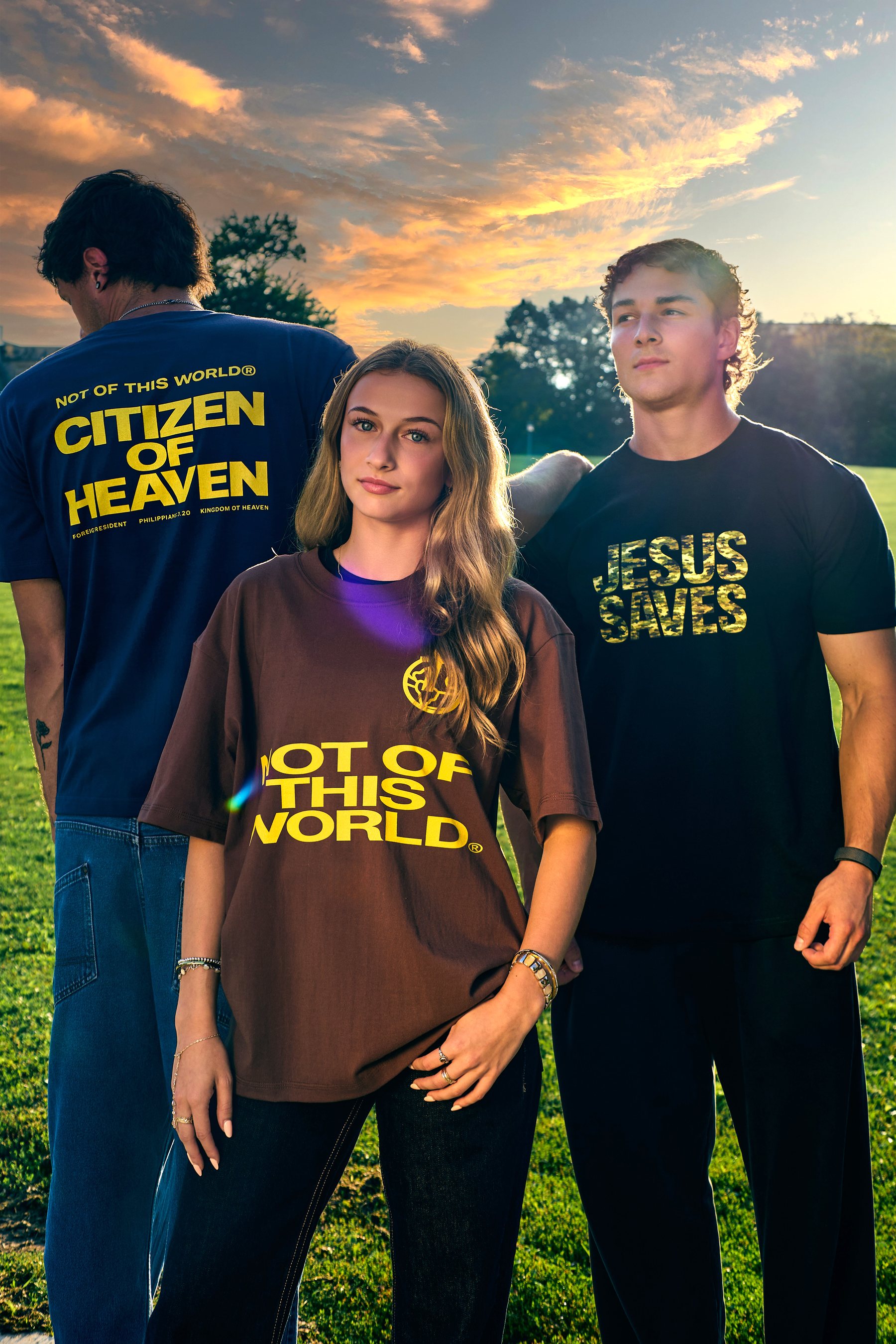 Models wearing Not Of This World tees at golden hour
